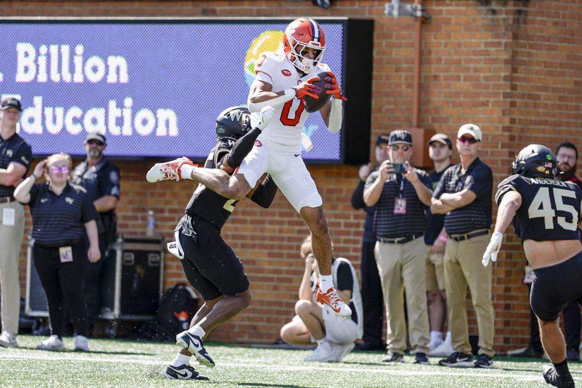 Oct 12, 2024; Winston-Salem, North Carolina, USA; Clemson Tigers wide receiver Antonio Williams (0) makes a scoring catch against Wake Forest Demon Deacons defensive back Jamare Glasker (25) during the first half at Allegacy Federal Credit Union Stadium. Mandatory Credit: Jim Dedmon-Imagn Images