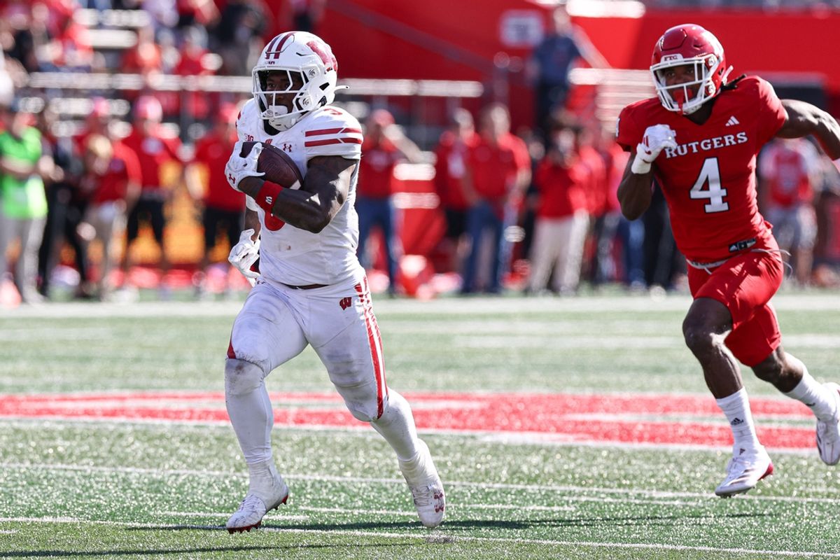 Oct 12, 2024; Piscataway, New Jersey, USA; Wisconsin Badgers running back Tawee Walker (3) rushes for a touchdown in front of Rutgers Scarlet Knights defensive back Desmond Igbinosun (4) during the second half at SHI Stadium. Mandatory Credit: Vincent Carchietta-Imagn Images
