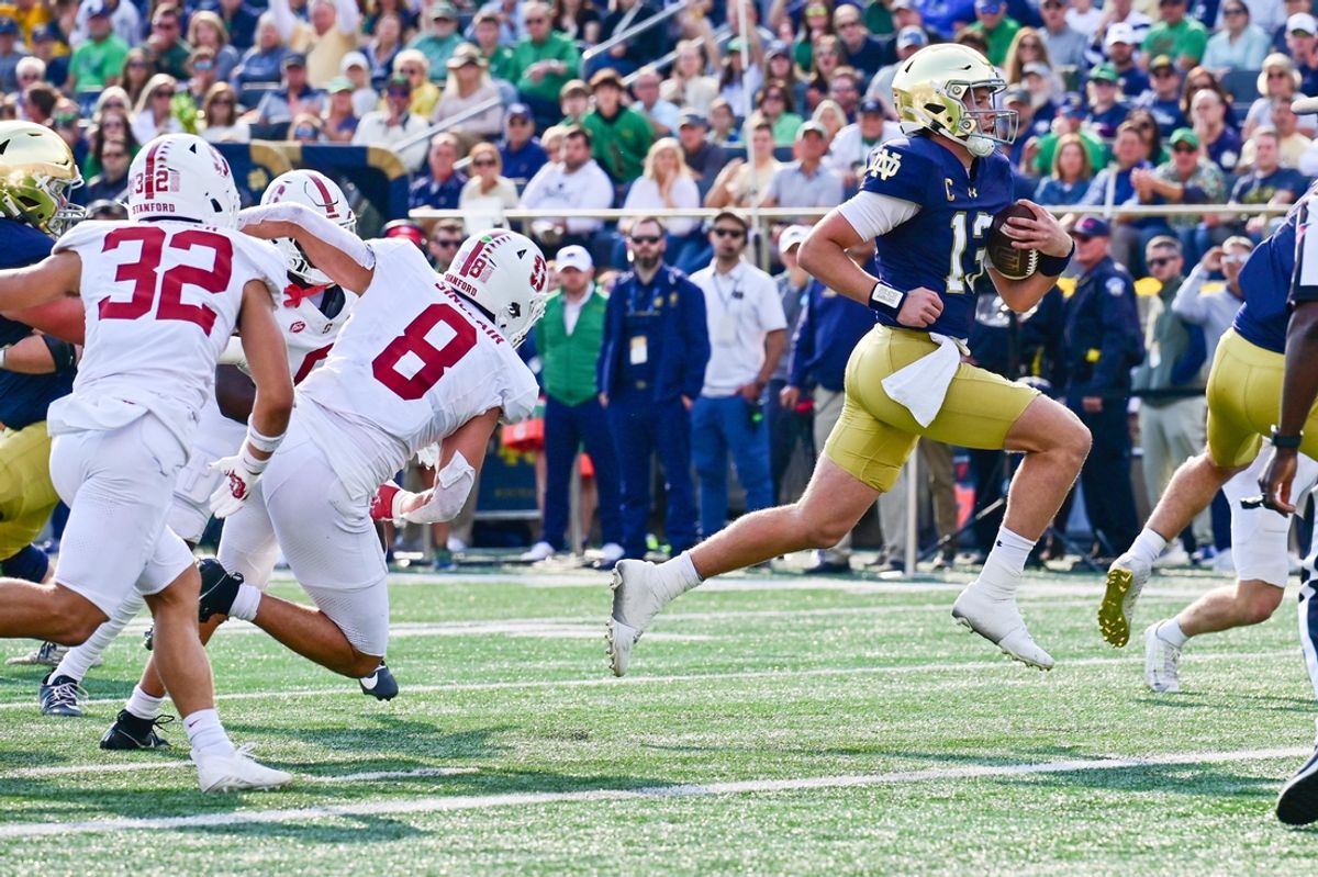 Oct 12, 2024; South Bend, Indiana, USA; Notre Dame Fighting Irish quarterback Riley Leonard (13) runs for a touchdown in the first quarter against the Stanford Cardinal at Notre Dame Stadium. Mandatory Credit: Matt Cashore-Imagn Images