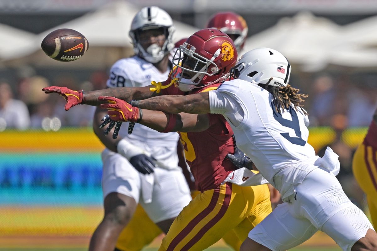 Oct 12, 2024; Los Angeles, California, USA; Penn State Nittany Lions quarterback Beau Pribula (9) breaks up a pass for USC Trojans wide receiver Kyron Hudson (10) in the first half at United Airlines Field at the Los Angeles Memorial Coliseum. Mandatory Credit: Jayne Kamin-Oncea-Imagn Images
