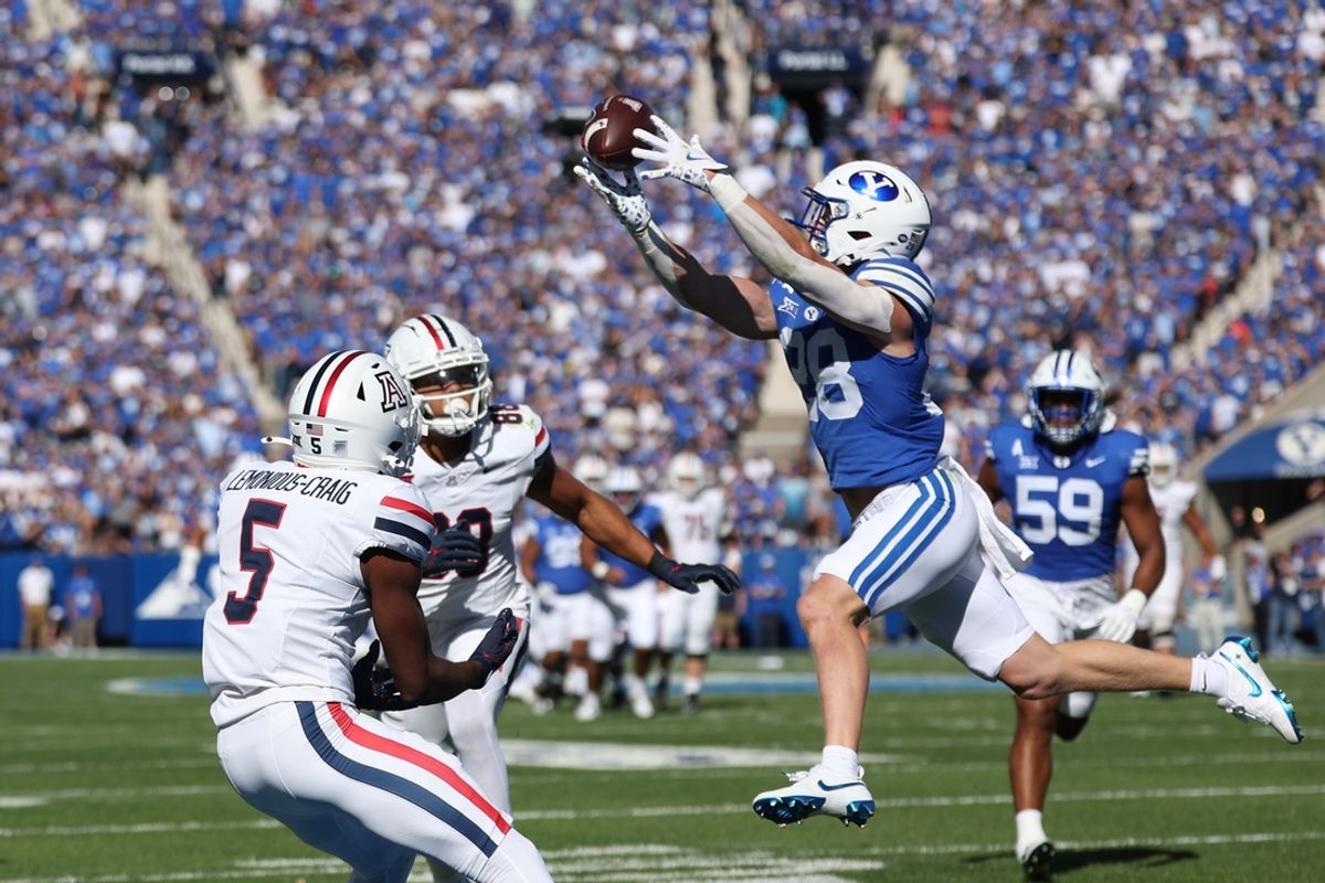 Oct 12, 2024; Provo, Utah, USA; Brigham Young Cougars safety Tanner Wall (28) intercepts a pass intended for Arizona Wildcats wide receiver Montana Lemonious-Craig (5) during the second quarter at LaVell Edwards Stadium. Mandatory Credit: Rob Gray-Imagn Images