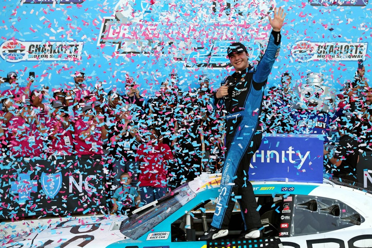 Oct 12, 2024; Concord, North Carolina, USA; Xfinity Series driver Sam Mayer (1) celebrates winning the Drive for the Cure 250 at Charlotte Motor Speedway Road Course. Mandatory Credit: Peter Casey-Imagn Images