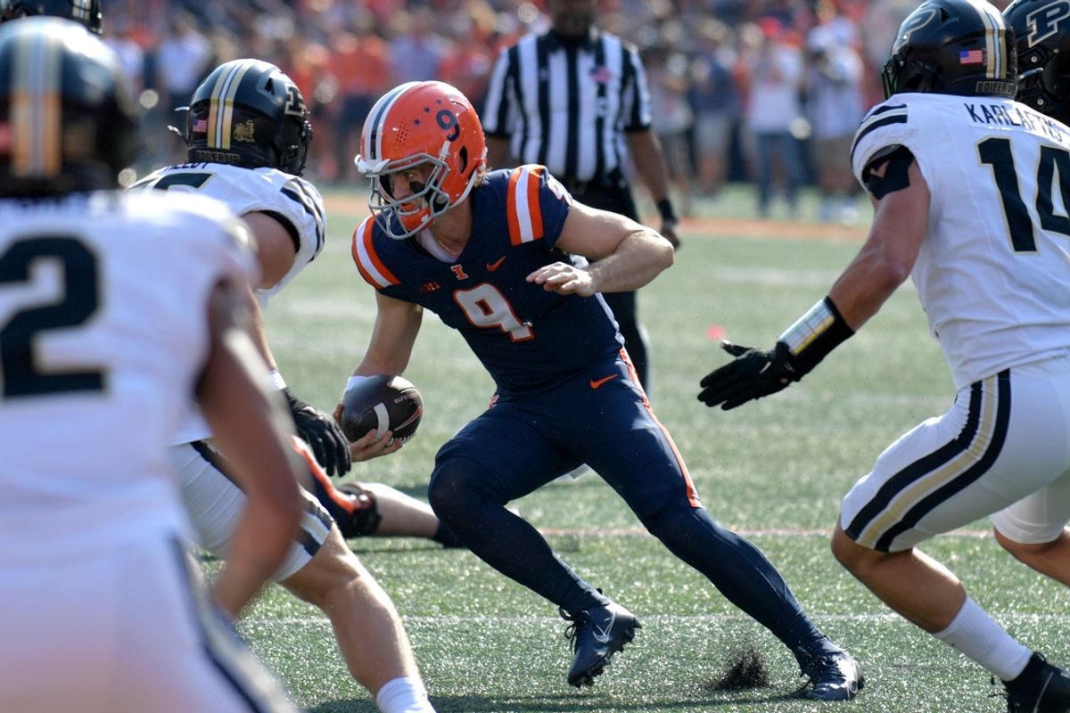Oct 12, 2024; Champaign, Illinois, USA;  Illinois Fighting Illini quarterback Luke Altmyer (9) runs with the ball in the first half against the Purdue Boilermakers at Memorial Stadium. Mandatory Credit: Ron Johnson-Imagn Images