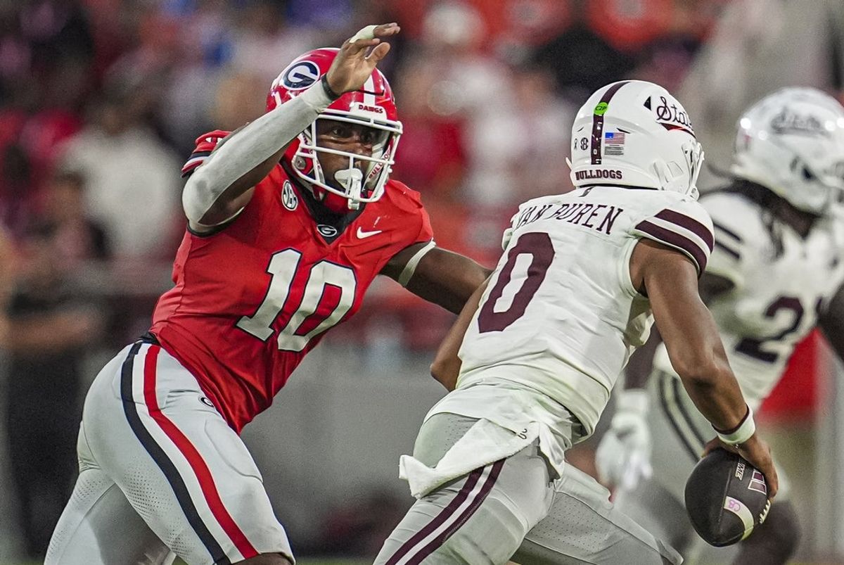 Oct 12, 2024; Athens, Georgia, USA; Georgia Bulldogs linebacker Damon Wilson II (10) tries to tackle Mississippi State Bulldogs quarterback Michael Van Buren Jr. (0) at Sanford Stadium. Mandatory Credit: Dale Zanine-Imagn Images