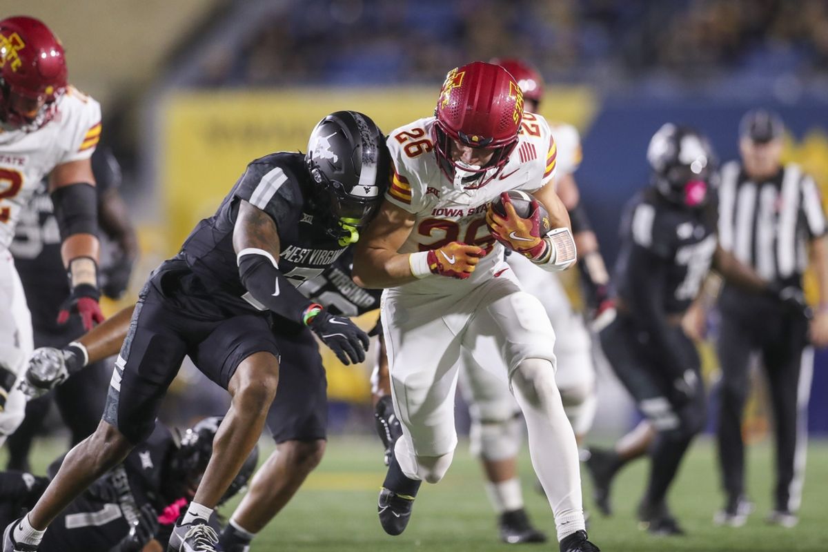Oct 12, 2024; Morgantown, West Virginia, USA; Iowa State Cyclones running back Carson Hansen (26) is tackled by West Virginia Mountaineers safety Jaheem Joseph (3) during the second quarter at Mountaineer Field at Milan Puskar Stadium. Mandatory Credit: Ben Queen-Imagn Images