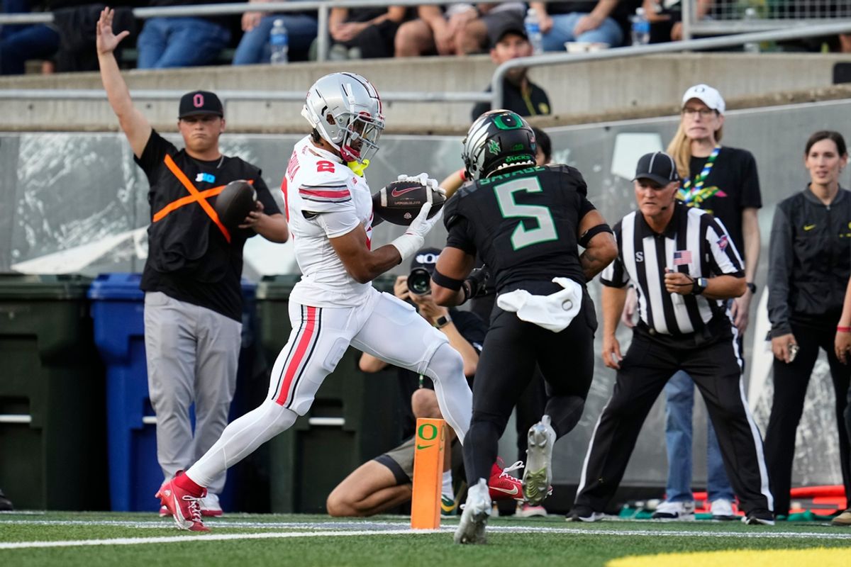 Oct 12, 2024; Eugene, Oregon, USA; Ohio State Buckeyes wide receiver Emeka Egbuka (2) catches a touchdown pass in front of Oregon Ducks defensive back Kobe Savage (5) during the first half of the NCAA football game at Autzen Stadium