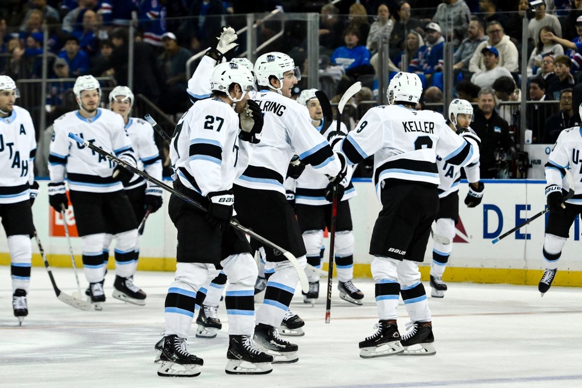 Oct 12, 2024; New York, New York, USA; Utah Hockey Club center Clayton Keller (9) celebrates with teammates after scoring a goal against the New York Rangers during the overtime period at Madison Square Garden. Mandatory Credit: John Jones-Imagn Images