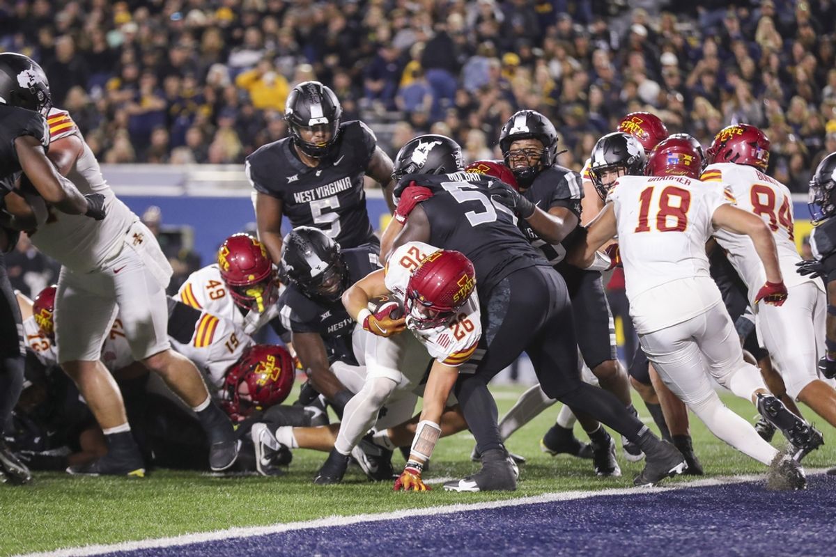 Oct 12, 2024; Morgantown, West Virginia, USA; Iowa State Cyclones running back Carson Hansen (26) runs for a touchdown against the West Virginia Mountaineers during the fourth quarter at Mountaineer Field at Milan Puskar Stadium. Mandatory Credit: Ben Queen-Imagn Images