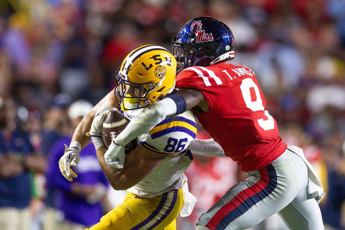 Oct 12, 2024; Baton Rouge, Louisiana, USA;  LSU Tigers tight end Mason Taylor (86) makes a first down against Mississippi Rebels cornerback Trey Amos (9) during the second half at Tiger Stadium. Mandatory Credit: Stephen Lew-Imagn Images