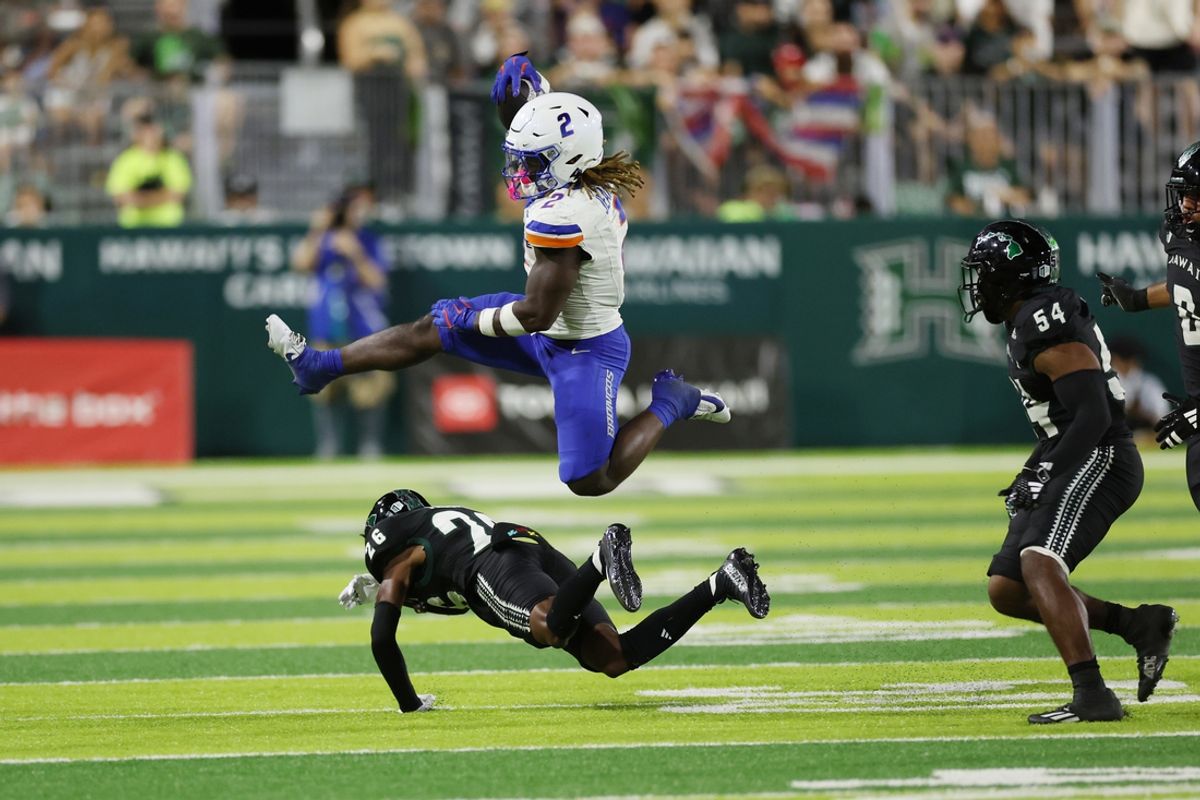Oct 12, 2024; Honolulu, Hawaii, USA;  Boise State Broncos running back Ashton Jeanty (2) leaps over Hawaii Rainbow Warriors defensive back Deliyon Freeman (26) during the second quarter at Clarence T.C. Ching Athletics Complex. The play was called back due to a Broncos foul. Mandatory Credit: Marco Garcia-Imagn Images