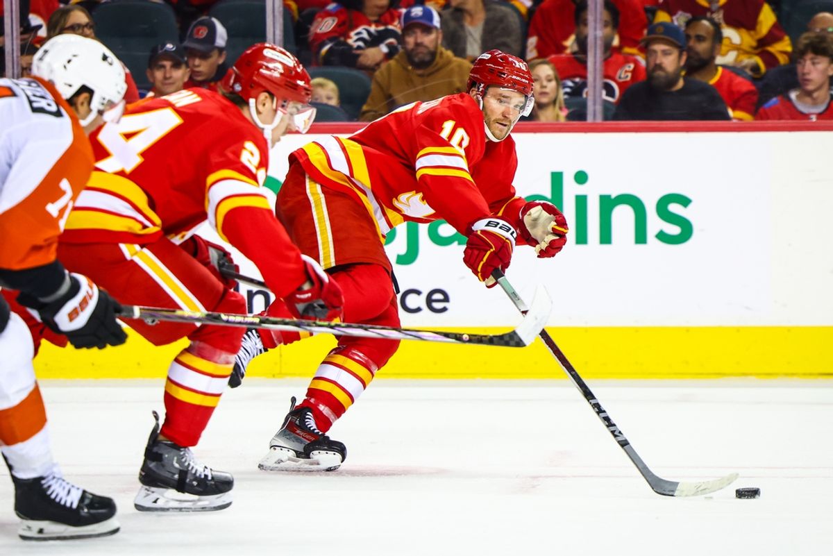 Oct 12, 2024; Calgary, Alberta, CAN; Calgary Flames center Jonathan Huberdeau (10) controls the puck against the Philadelphia Flyers during the third period at Scotiabank Saddledome. Mandatory Credit: Sergei Belski-Imagn Images