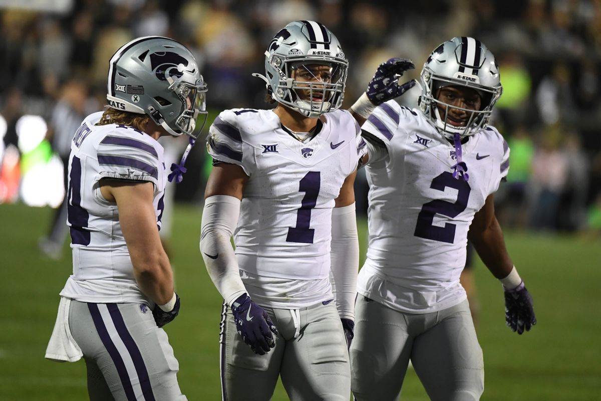Oct 12, 2024; Boulder, Colorado, USA; Kansas State Wildcats safety Jet Dineen (14) cornerback Keenan Garber (1) and safety Colby McCalister (2) celebrate after a defensive stop during the second half against the Colorado Buffaloes at Folsom Field. Mandatory Credit: Christopher Hanewinckel-Imagn Images
