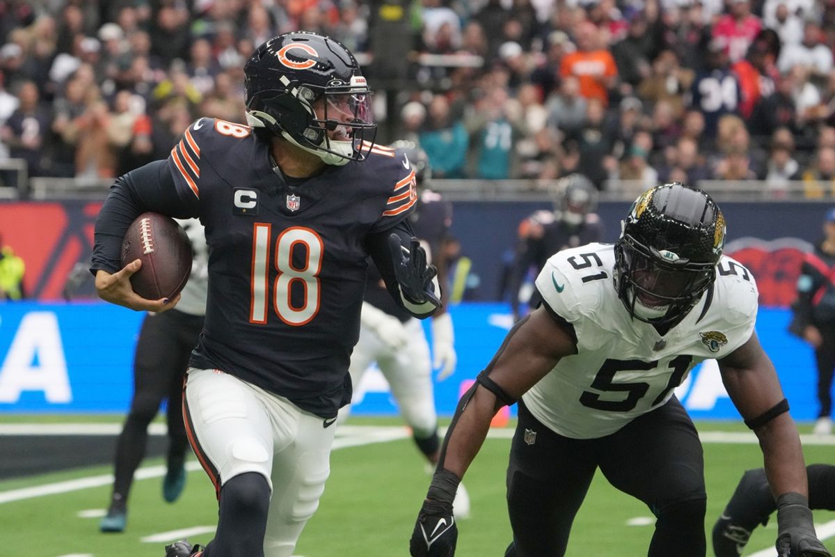 Oct 13, 2024; London, United Kingdom; Chicago Bears quarterback Caleb Williams (18) carries the ball against Jacksonville Jaguars linebacker Ventrell Miller (51) in the first half during an NFL International Series game at Tottenham Hotspur Stadium. Mandatory Credit: Kirby Lee-Imagn Images