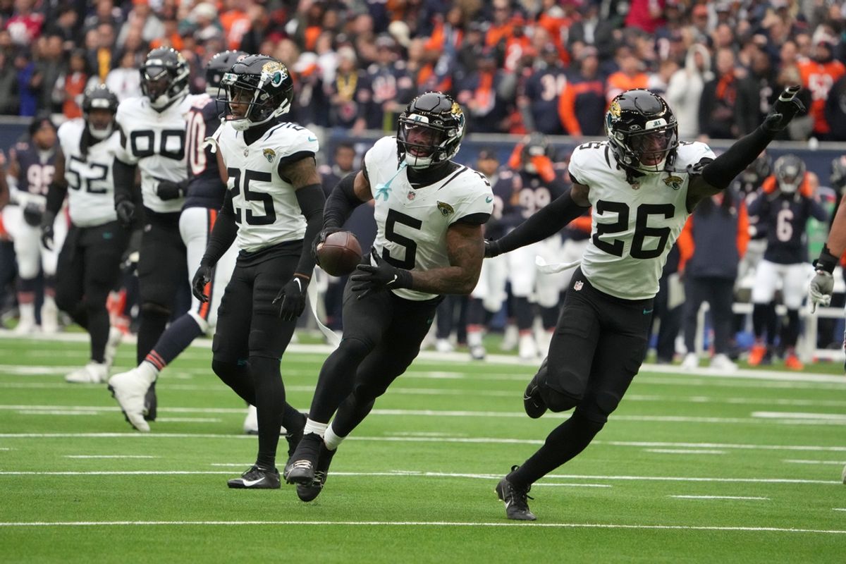 Oct 13, 2024; London, United Kingdom; Jacksonville Jaguars safety Andre Cisco (5) and safety Antonio Johnson (26) celebrate after an interception against the Chicago Bears in the first half during an NFL International Series game at Tottenham Hotspur Stadium. Mandatory Credit: Kirby Lee-Imagn Images