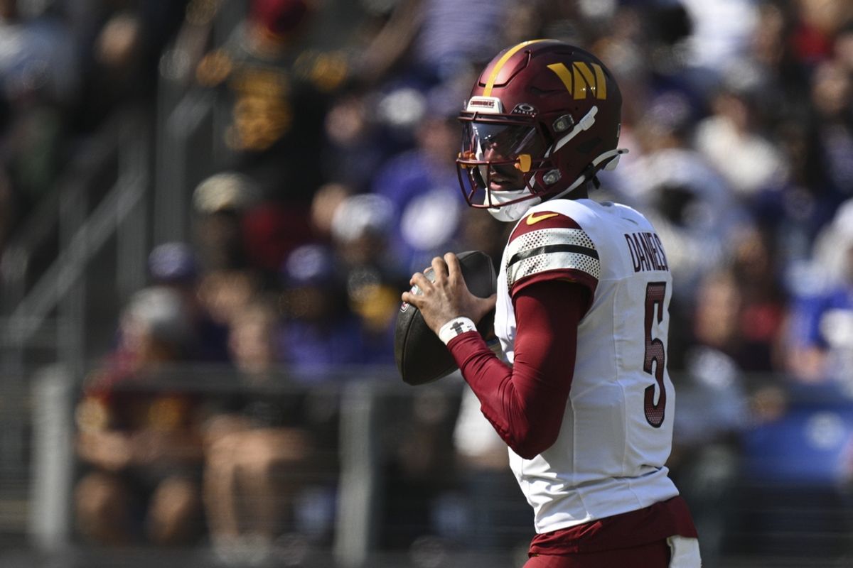 Oct 13, 2024; Baltimore, Maryland, USA;  Washington Commanders quarterback Jayden Daniels (5) loos to throws during the first quarter against the Baltimore Ravens at M&T Bank Stadium. Mandatory Credit: Tommy Gilligan-Imagn Images