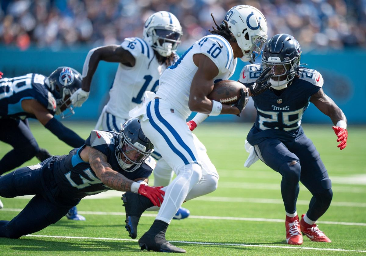 Tennessee Titans safety Amani Hooker (37) and cornerback Jarvis Brownlee Jr. (29) stop Indianapolis Colts wide receiver Adonai Mitchell (10) on a third down play during the first half of their game at Nissan Stadium in Nashville, Tenn., Monday, Oct. 14, 2024.