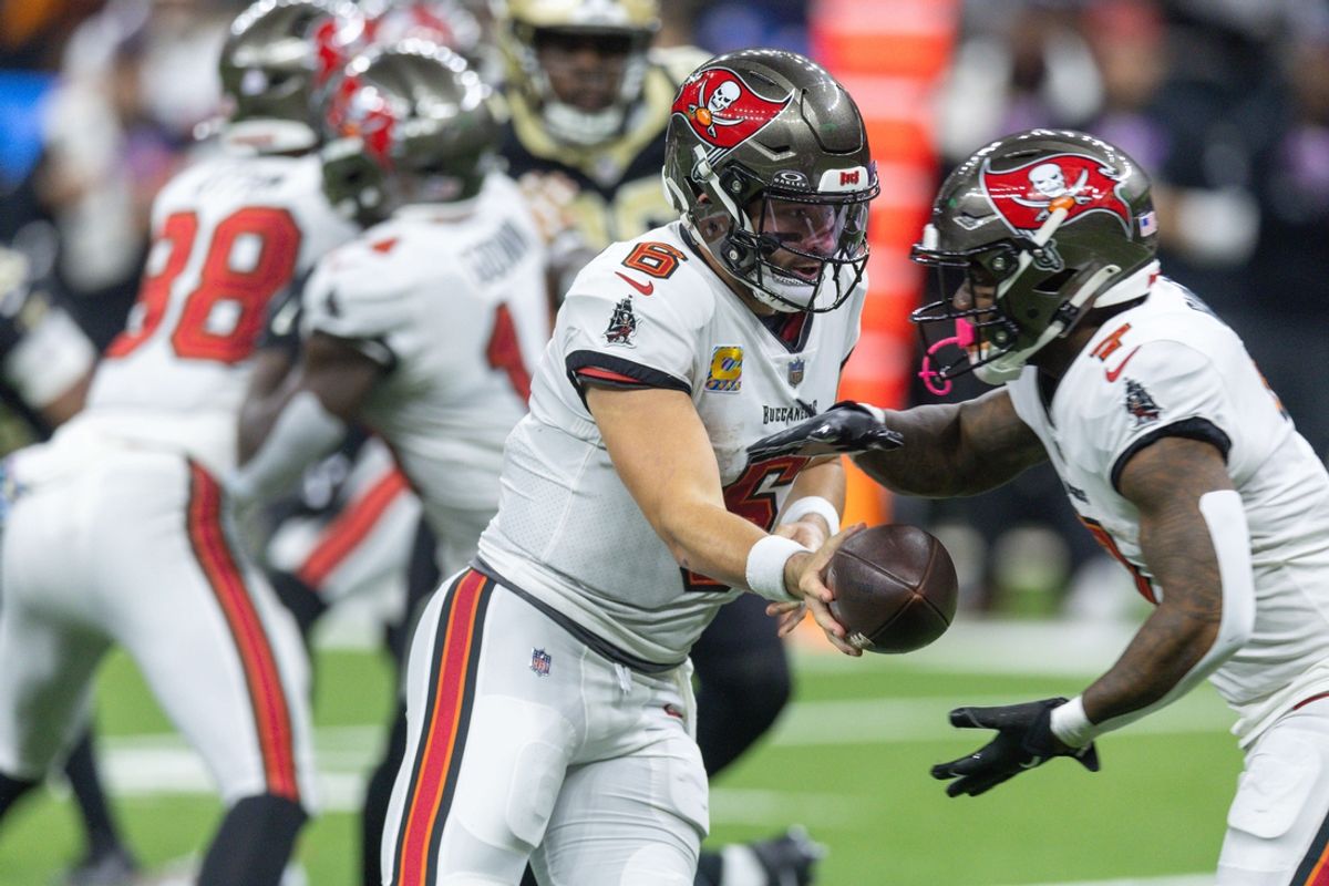 Oct 13, 2024; New Orleans, Louisiana, USA;  Tampa Bay Buccaneers quarterback Baker Mayfield (6) hands off to running back Bucky Irving (7) against the New Orleans Saints during the first half at Caesars Superdome. Mandatory Credit: Stephen Lew-Imagn Images