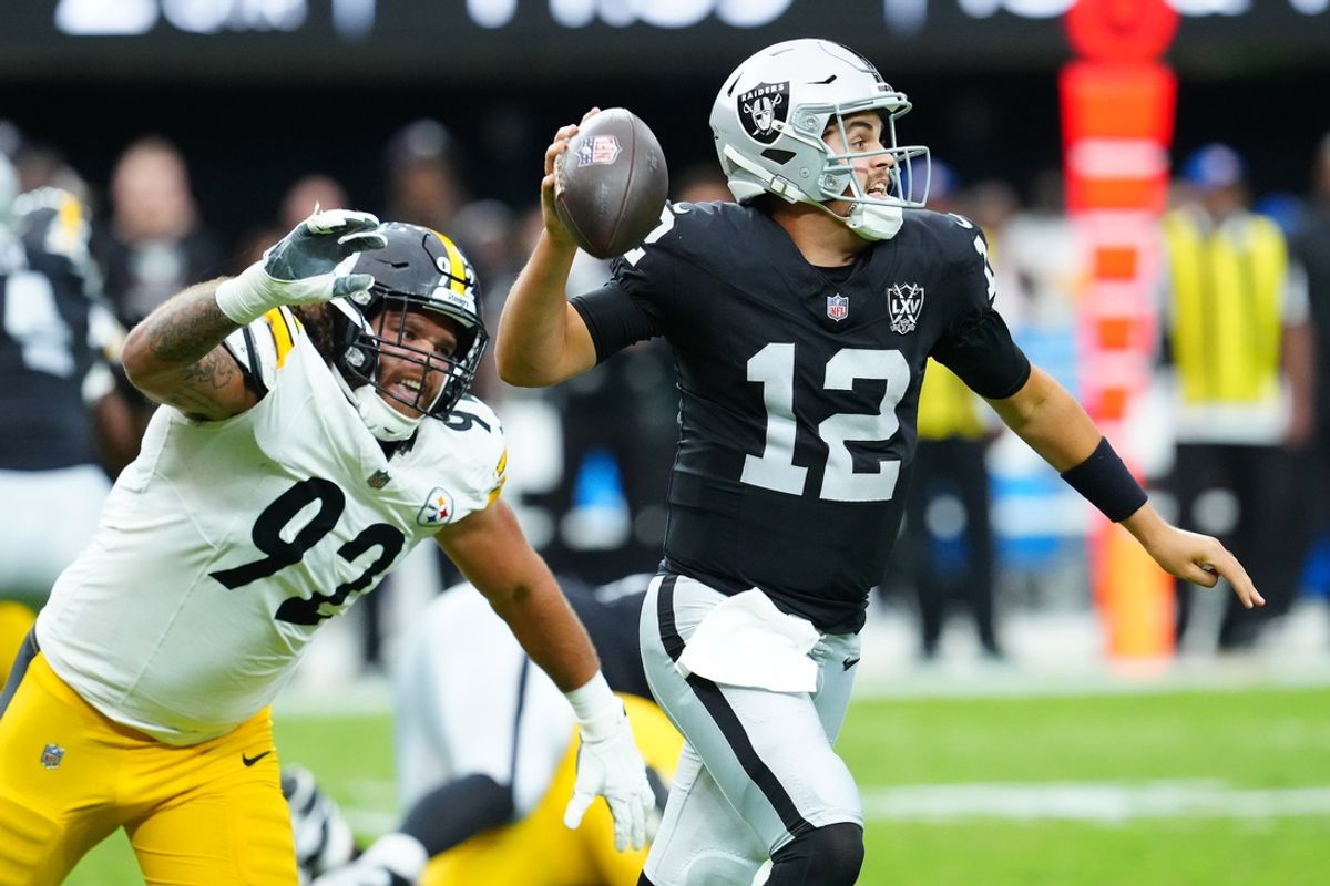 Oct 13, 2024; Paradise, Nevada, USA; Las Vegas Raiders quarterback Aidan O'Connell (12) is flushed from the pocket by Pittsburgh Steelers defensive tackle Isaiahh Loudermilk (92) during the second quarter at Allegiant Stadium. Mandatory Credit: Stephen R. Sylvanie-Imagn Images