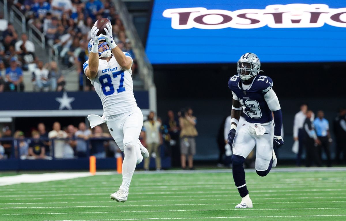 Oct 13, 2024; Arlington, Texas, USA;  Detroit Lions tight end Sam LaPorta (87) catches a pass past Dallas Cowboys linebacker DeMarvion Overshown (13) and scores a touchdown during the second quarter at AT&T Stadium. Mandatory Credit: Kevin Jairaj-Imagn Images