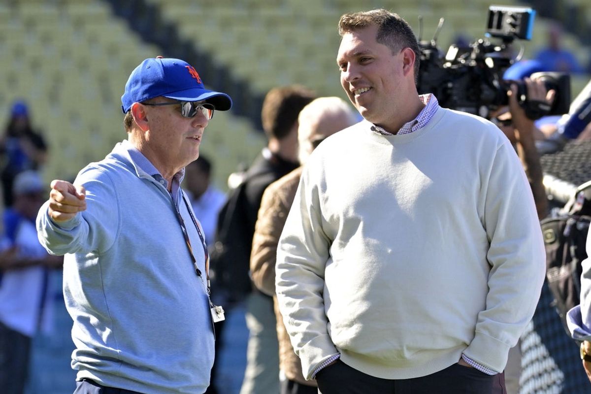 Oct 13, 2024; Los Angeles, California, USA; New York Mets owner Steve Cohen (left) talks with general manager David Stearns (right) before game one of the NLCS for the 2024 MLB Playoffs at Dodger Stadium. Mandatory Credit: Jayne Kamin-Oncea-Imagn Images