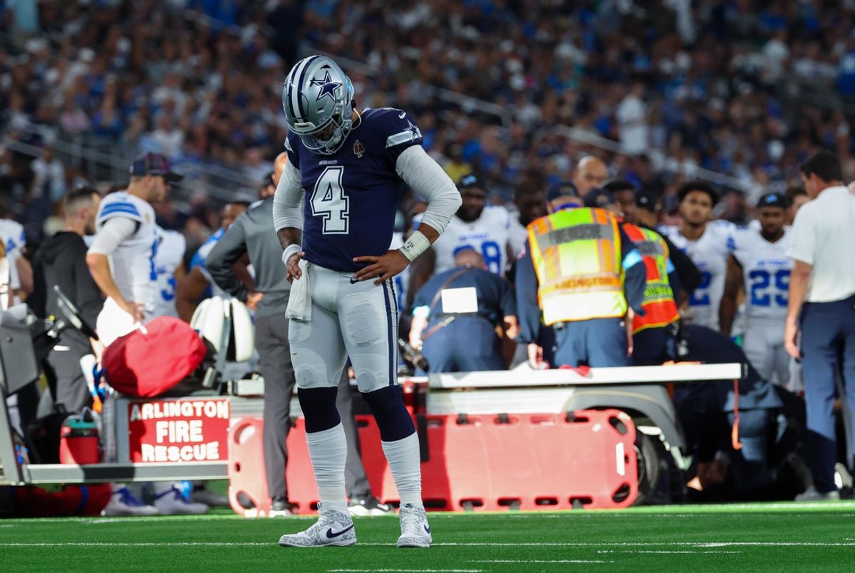 Oct 13, 2024; Arlington, Texas, USA;  Dallas Cowboys quarterback Dak Prescott (4) says a prayer for Detroit Lions injured defensive end Aidan Hutchinson (97) during the second half at AT&T Stadium. Mandatory Credit: Kevin Jairaj-Imagn Images