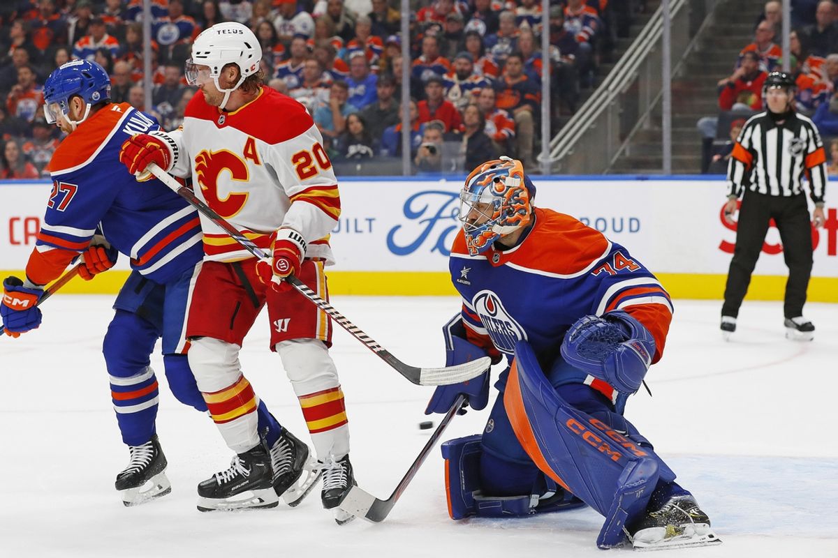 Oct 13, 2024; Edmonton, Alberta, CAN; Calgary Flames forward Blake Coleman (20) deflects a shot wide of Edmonton Oilers goaltender Stuart Skinner (74) during the second period at Rogers Place. Mandatory Credit: Perry Nelson-Imagn Images