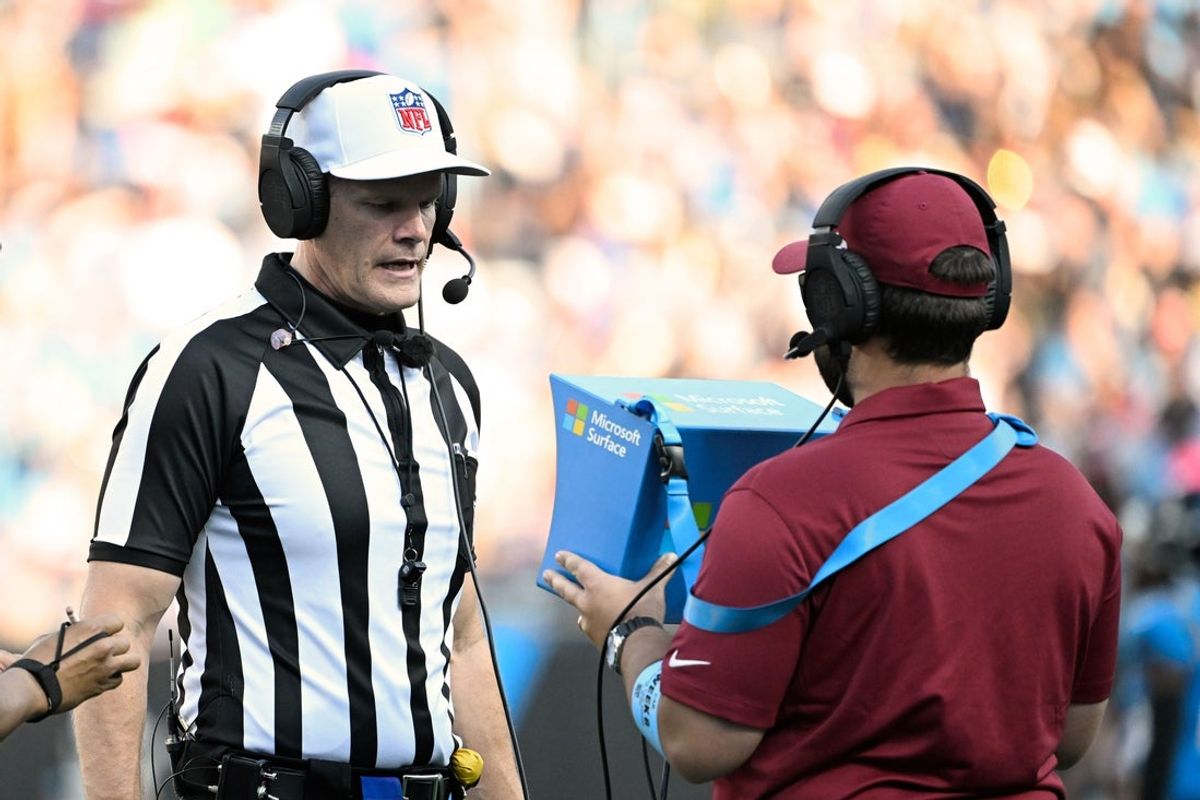 Oct 13, 2024; Charlotte, North Carolina, USA; The referee looks as instant replay in the second quarter at Bank of America Stadium. Mandatory Credit: Bob Donnan-Imagn Images