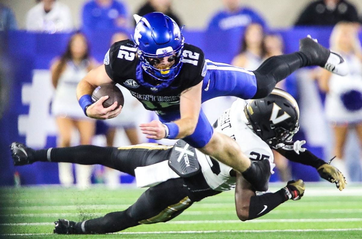 Quarterback Brock Vandagriff (12) dives as he's tackled by cornerback Martel Hight (25) of the Vanderbilt Commodores. The Commodores defeated the Wildcats 20-13 at Kroger Field Saturday, Oct. 12, 2024 in Lexington, Ky.