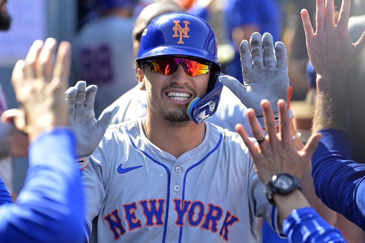 Oct 14, 2024; Los Angeles, California, USA; New York Mets outfielder Tyrone Taylor (15) celebrates after scoring on a grand slam home run by third baseman Mark Vientos (not pictured) in the second inning against the Los Angeles Dodgers during game two of the NLCS for the 2024 MLB Playoffs at Dodger Stadium. Mandatory Credit: Jayne Kamin-Oncea-Imagn Images
