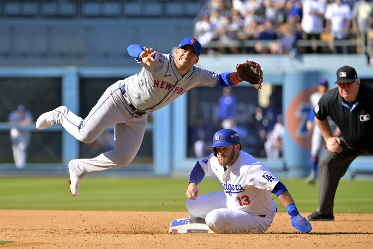 Oct 14, 2024; Los Angeles, California, USA; Los Angeles Dodgers third baseman Max Muncy (13) is out at second base against New York Mets second baseman Jose Iglesias (11) on a double play in the sixth inning during game two of the NLCS for the 2024 MLB Playoffs at Dodger Stadium. Mandatory Credit: Jayne Kamin-Oncea-Imagn Images