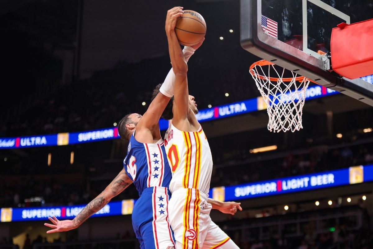 Oct 14, 2024; Atlanta, Georgia, USA; Philadelphia 76ers forward Caleb Martin (16) fouls Atlanta Hawks forward Zaccharie Risacher (10) on a dunk attempt in the third quarter at State Farm Arena. Mandatory Credit: Brett Davis-Imagn Images
