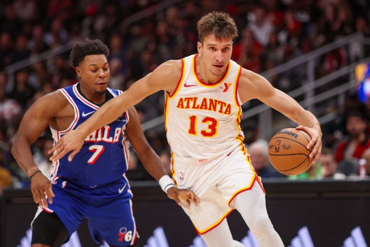 Oct 14, 2024; Atlanta, Georgia, USA; Atlanta Hawks guard Bogdan Bogdanovic (13) drives past Philadelphia 76ers guard Kyle Lowry (7) in the third quarter at State Farm Arena. Mandatory Credit: Brett Davis-Imagn Images