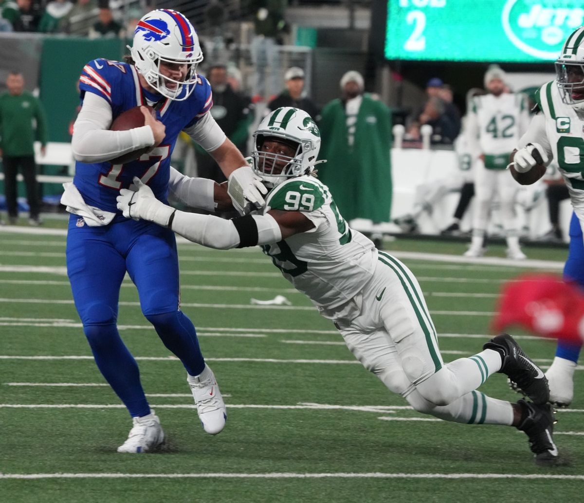 East Rutherford, NJ -- October 14, 2024 -- Josh Allen of Buffalo breaks away from a tackle by Will McDonald IV of the Jets in the first half. The Buffalo Bills came to MetLife Stadium to play the NY Jets. The Jets played their first game under new interim head coach Jeff Ulbrich.