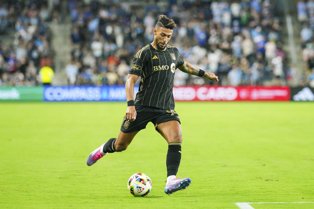 Oct 5, 2024; Kansas City, Kansas, USA; LAFC forward Denis Bouanga (99) kicks the ball during the first half against Sporting Kansas City at Children's Mercy Park. Mandatory Credit: Jay Biggerstaff-Imagn Images