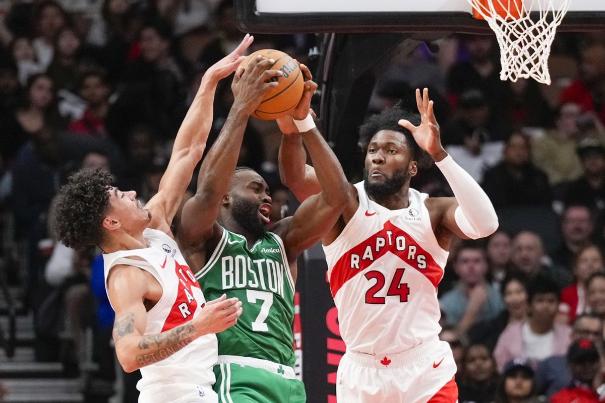 Oct 15, 2024; Toronto, Ontario, CAN; Boston Celtics guard Jaylen Brown (7) drives to the net against Toronto Raptors forward Bruno Fernando (24) and guard D.J. Carton (3) during the second half at Scotiabank Arena. Mandatory Credit: Kevin Sousa-Imagn Images