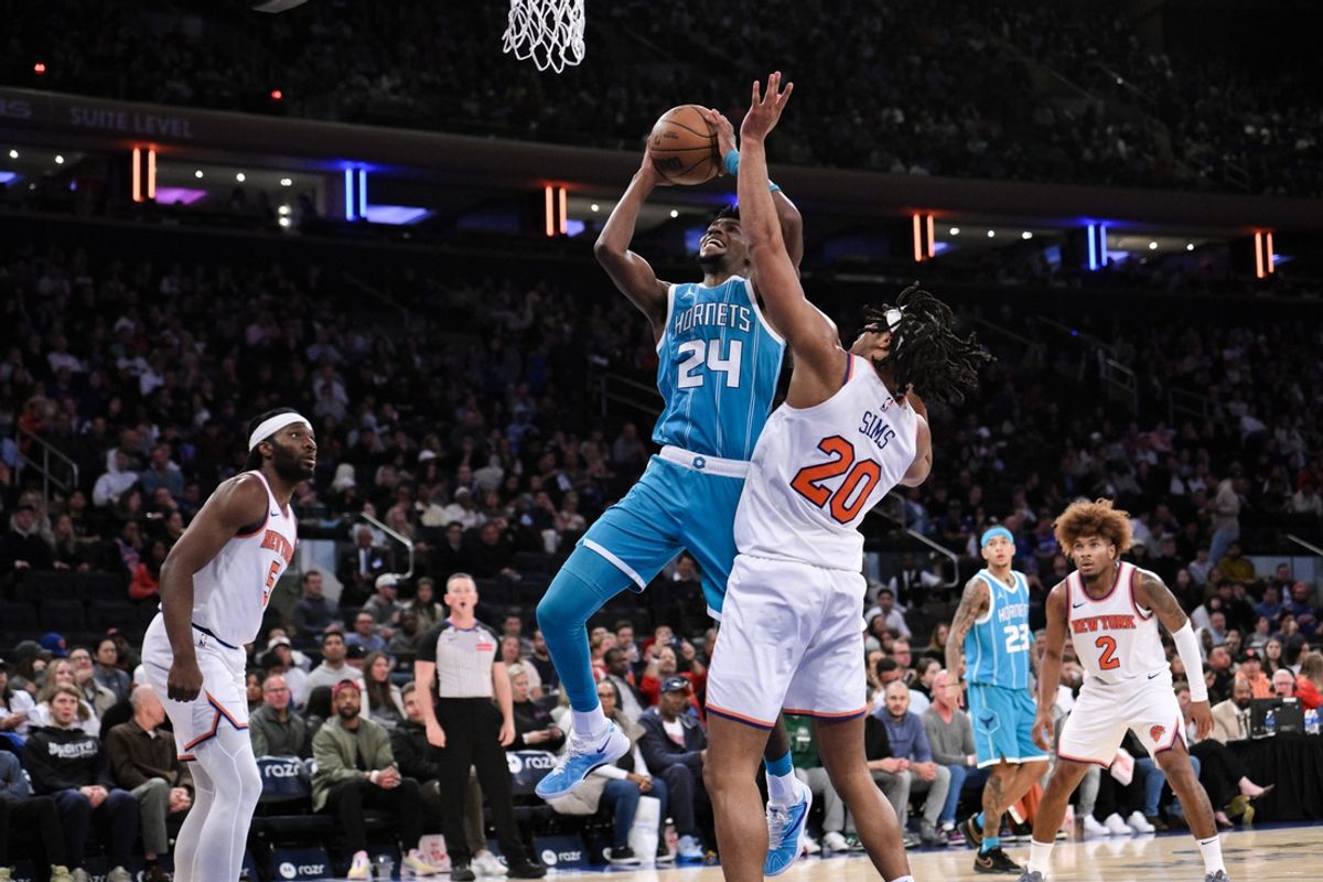 Oct 15, 2024; New York, New York, USA; Charlotte Hornets forward Brandon Miller (24) shoots the ball while being defended by New York Knicks center Jericho Sims (20) during the second half at Madison Square Garden. Mandatory Credit: John Jones-Imagn Images