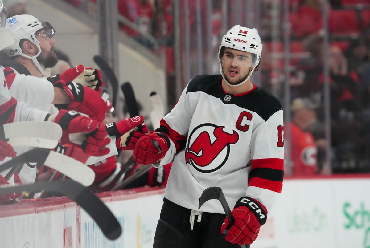 Oct 15, 2024; Raleigh, North Carolina, USA;  New Jersey Devils center Nico Hischier (13) celebrates his goal against the Carolina Hurricanes during the third period at PNC Arena. Mandatory Credit: James Guillory-Imagn Images