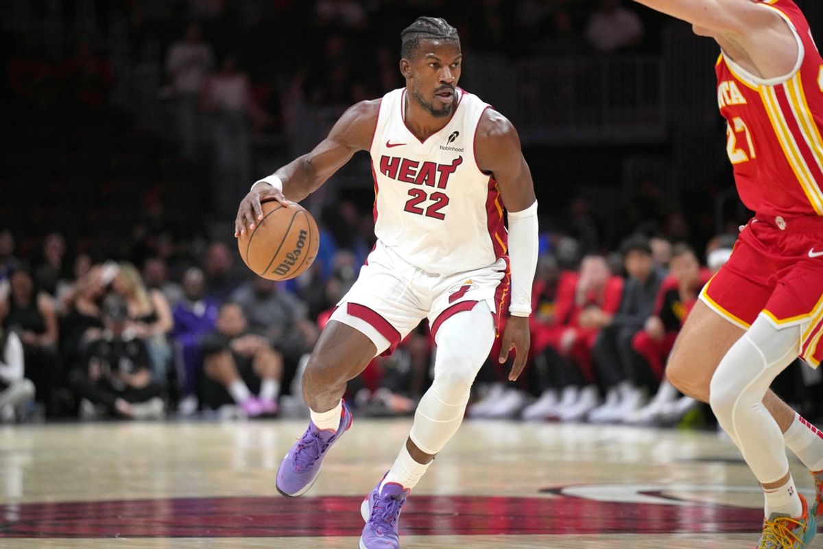 Oct 16, 2024; Miami, Florida, USA; Miami Heat forward Jimmy Butler (22) brings the ball up the court as Atlanta Hawks guard Vit Krejci (27) defends in the first half at Kaseya Center. Mandatory Credit: Jim Rassol-Imagn Images