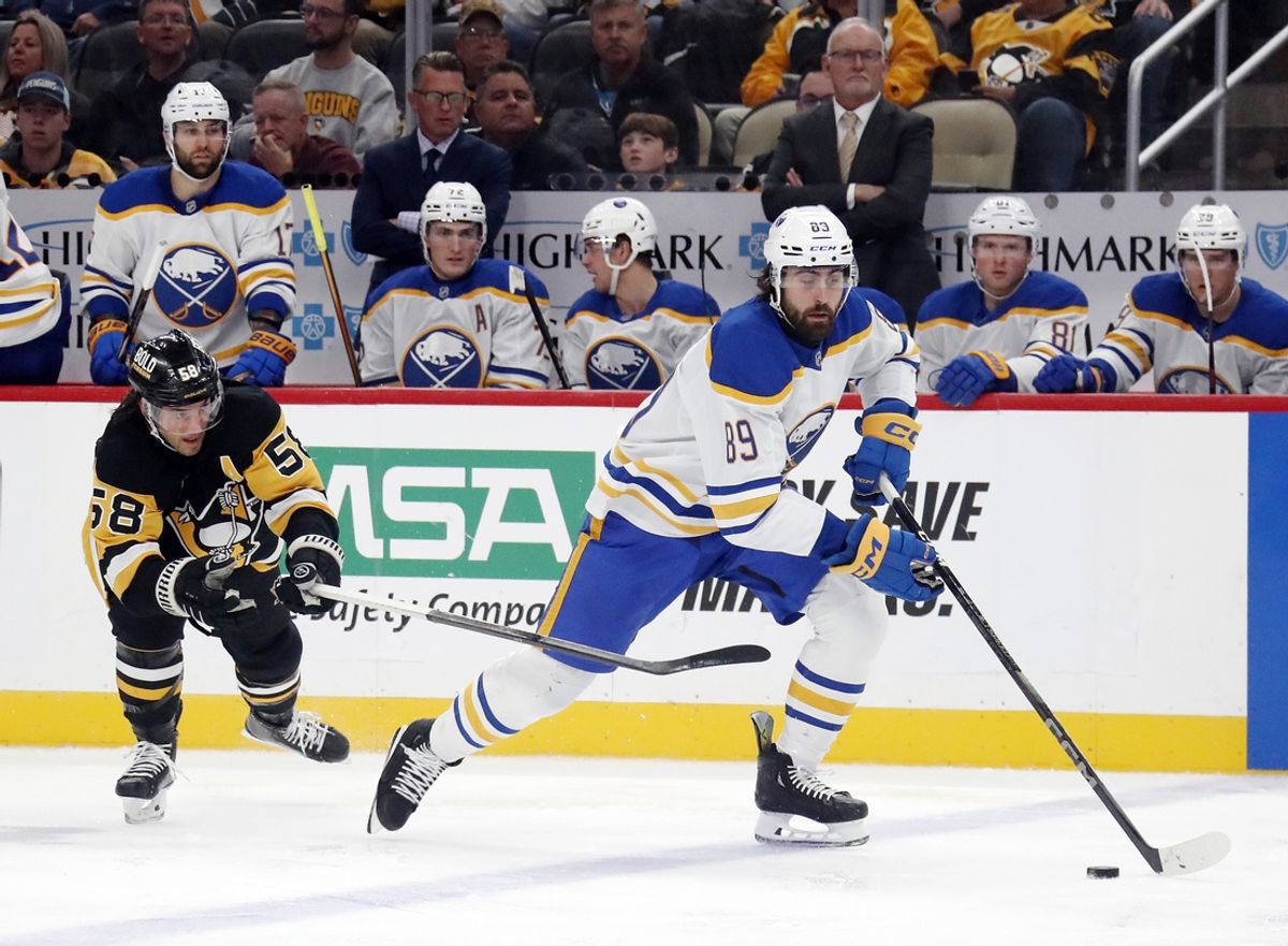 Oct 16, 2024; Pittsburgh, Pennsylvania, USA; Buffalo Sabres right wing Alex Tuch (89) handles the puck ahead of Pittsburgh Penguins defenseman Kris Letang (58) during the third period at PPG Paints Arena. Mandatory Credit: Charles LeClaire-Imagn Images
