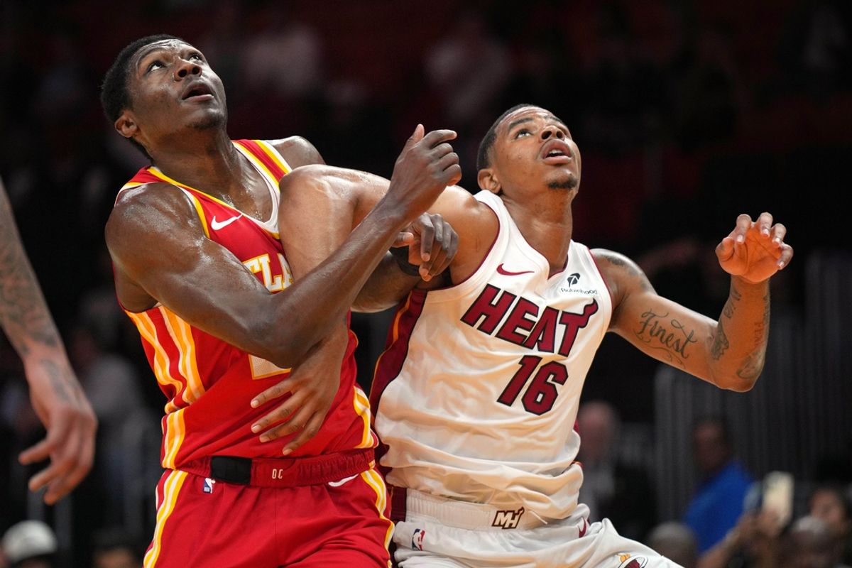 Oct 16, 2024; Miami, Florida, USA;  Atlanta Hawks guard Daeqwon Plowden (29) and Miami Heat forward Keshad Johnson (16) battle for rebound position in the second half at Kaseya Center. Mandatory Credit: Jim Rassol-Imagn Images