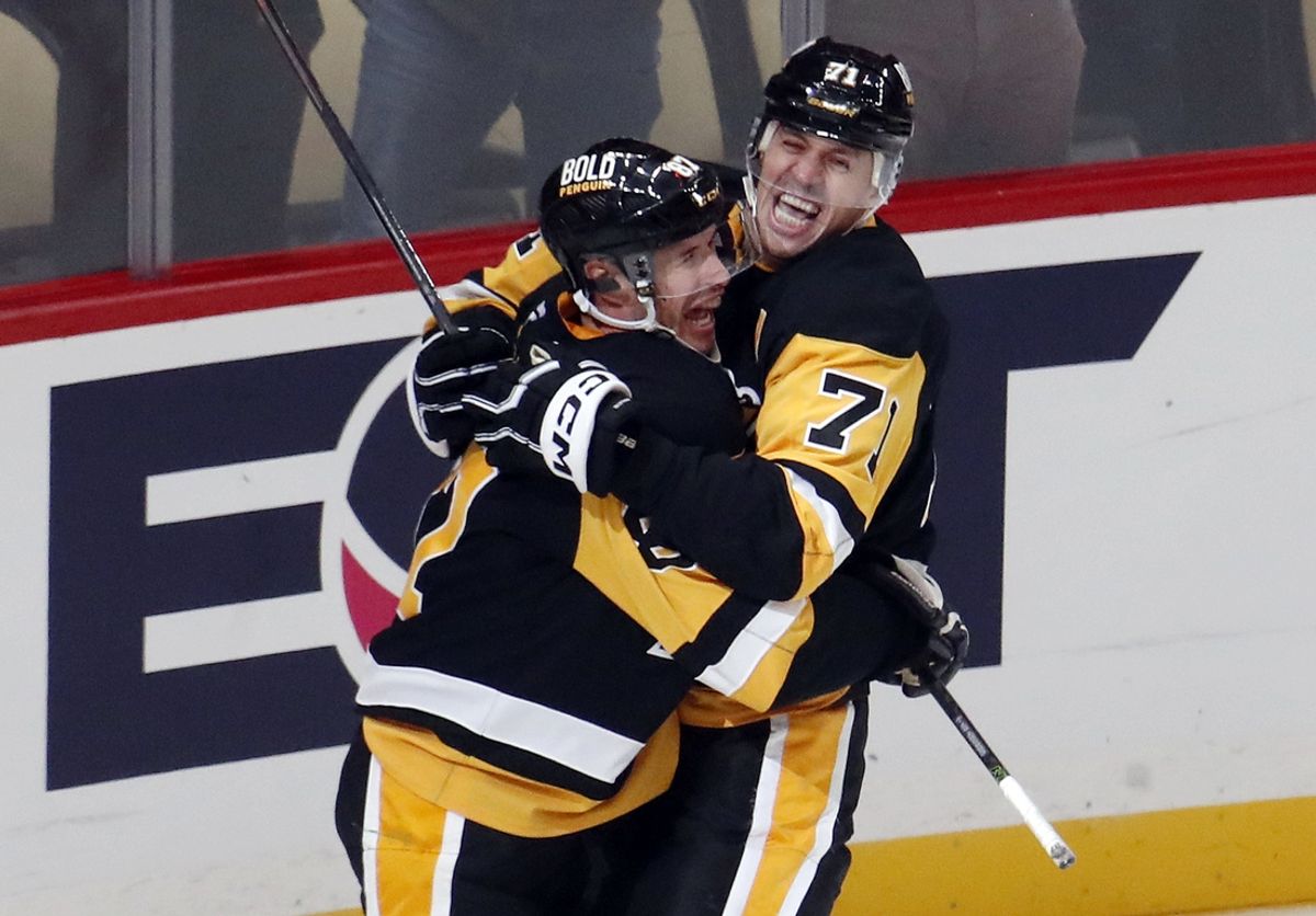 Oct 16, 2024; Pittsburgh, Pennsylvania, USA;  Pittsburgh Penguins center Sidney Crosby (87) and center Evgeni Malkin (71) celebrate after Crosby scored the game winning power play goal in overtime to defeat the Buffalo Sabres at PPG Paints Arena. Mandatory Credit: Charles LeClaire-Imagn Images