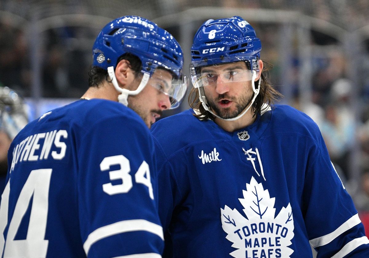 Oct 16, 2024; Toronto, Ontario, CAN; Toronto Maple Leafs defenseman Chris Tanev (8) speaks with forward Auston Matthews in the second period against the Los Angeles Kings at Scotiabank Arena. Mandatory Credit: Dan Hamilton-Imagn Images