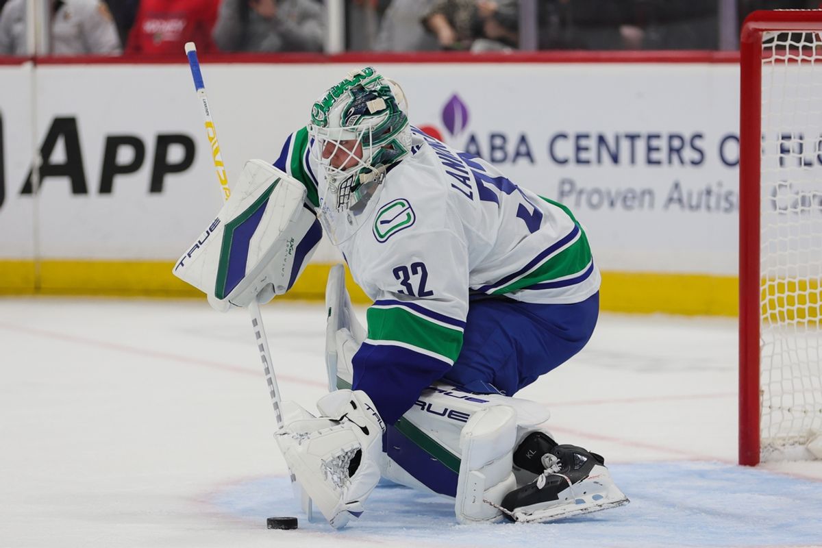 Oct 17, 2024; Sunrise, Florida, USA; Vancouver Canucks goaltender Kevin Lankinen (32) controls the puck against the Florida Panthers during the first period at Amerant Bank Arena. Mandatory Credit: Sam Navarro-Imagn Images