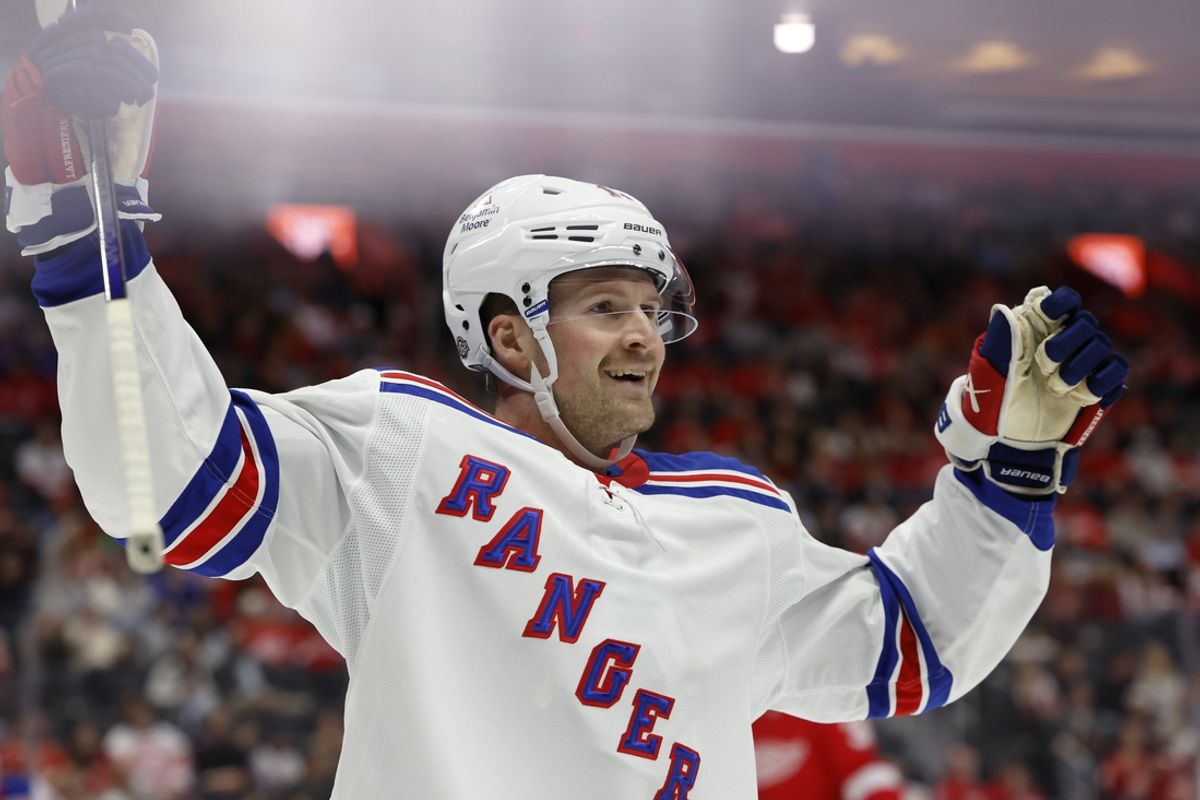 Oct 17, 2024; Detroit, Michigan, USA;  New York Rangers left wing Alexis Lafrenière (13) celebrates a goal by left wing Artemi Panarin (not pictured) in the first period against the Detroit Red Wings at Little Caesars Arena. Mandatory Credit: Rick Osentoski-Imagn Images