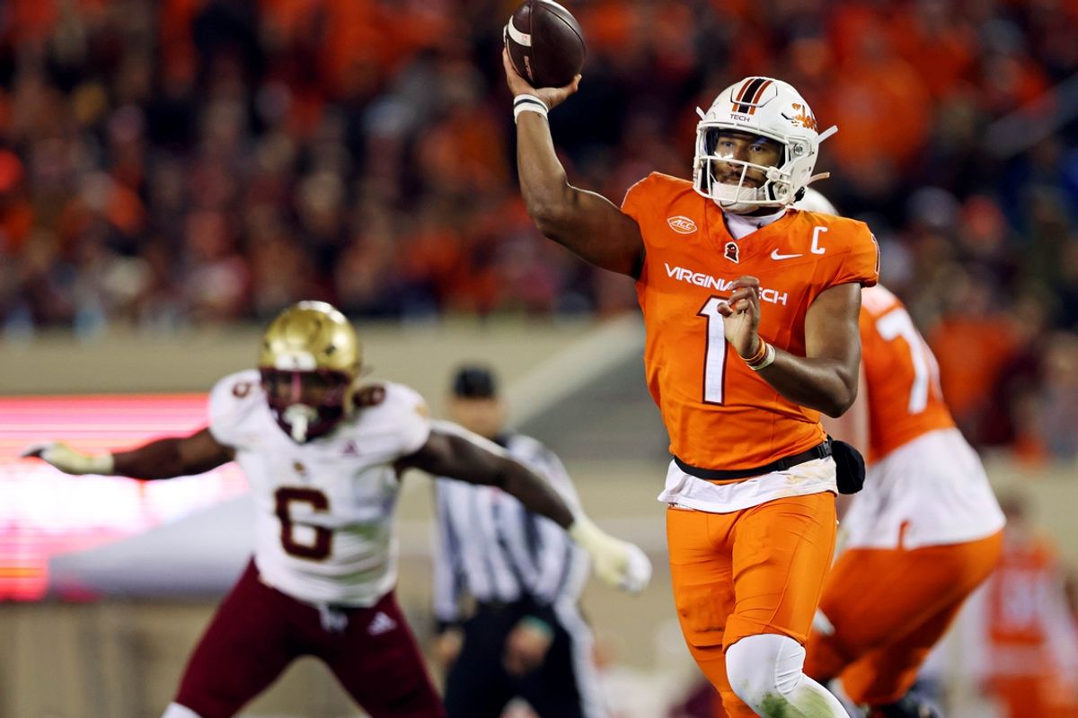 Oct 17, 2024; Blacksburg, Virginia, USA; Virginia Tech Hokies quarterback Kyron Drones (1) throws a touchdown during the second quarter against the Boston College Eagles at Lane Stadium. Mandatory Credit: Peter Casey-Imagn Images