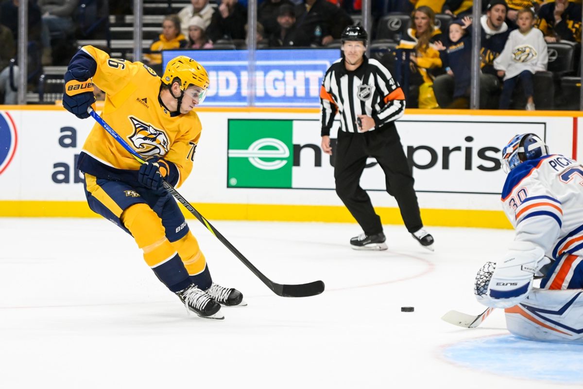 Oct 17, 2024; Nashville, Tennessee, USA;  Edmonton Oilers goaltender Calvin Pickard (30) blocks the shot of Nashville Predators defenseman Brady Skjei (76) during the first period at Bridgestone Arena. Mandatory Credit: Steve Roberts-Imagn Images