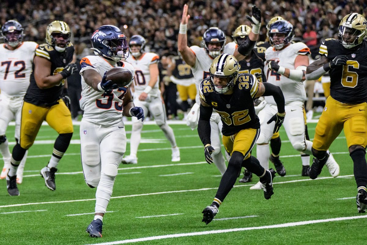 Oct 17, 2024; New Orleans, Louisiana, USA; Denver Broncos running back Javonte Williams (33) scores a touchdown against New Orleans Saints safety Tyrann Mathieu (32) during the second quarter at Caesars Superdome. Mandatory Credit: Matthew Hinton-Imagn Images
