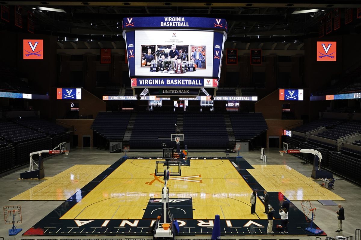 Oct 18, 2024; Charlottesville, VA, US; Virginia Cavaliers head men's basketball coach Tony Bennett (R) and Virginia athletic director Karla Williams (L) talk on the court after a press conference announcing Bennett's immediate retirement at John Paul Jones Arena. Mandatory Credit: Geoff Burke-Imagn Images