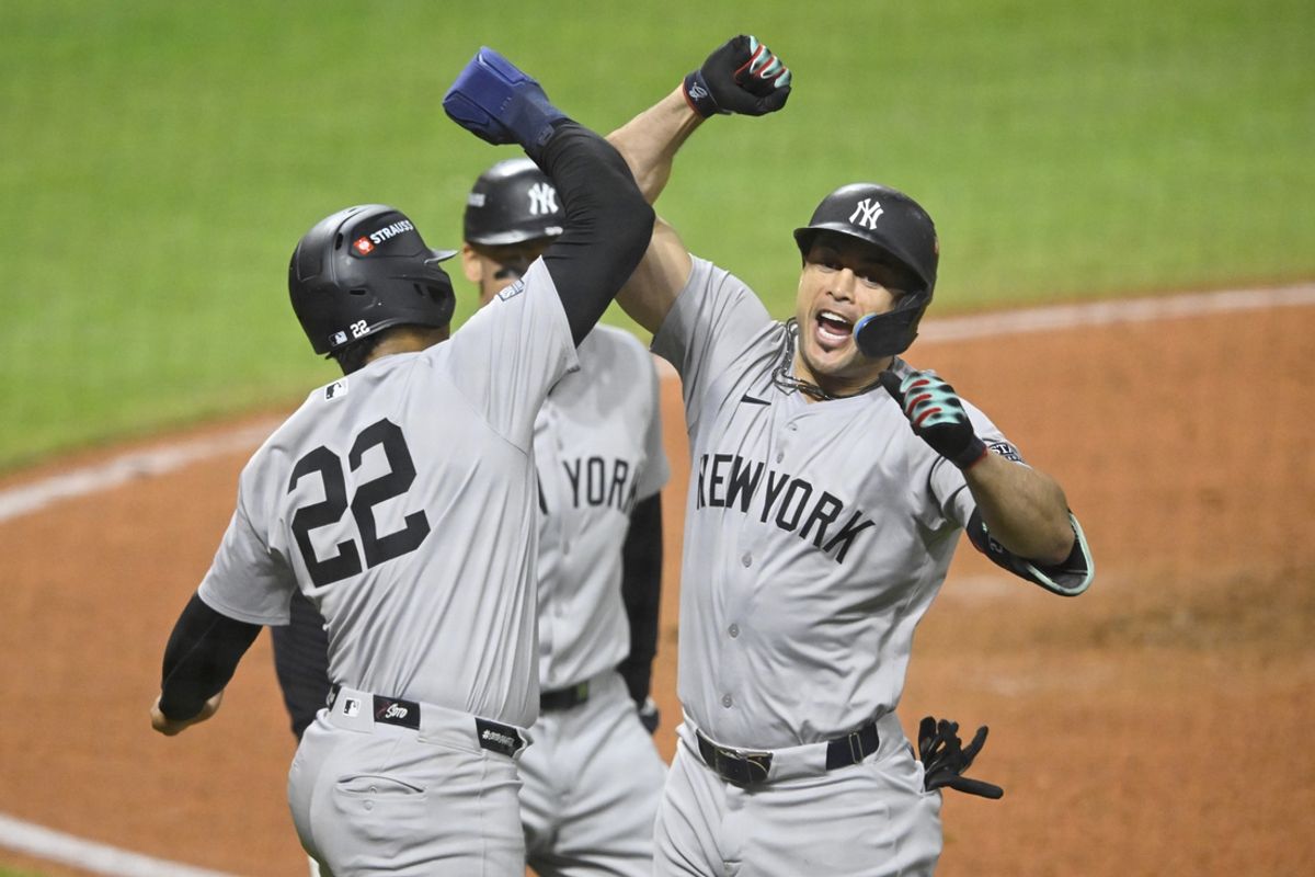 Oct 18, 2024; Cleveland, Ohio, USA; New York Yankees designated hitter Giancarlo Stanton (27) celebrates a three run home run with outfielder Juan Soto (22) in the sixth inning against the Cleveland Guardians during game four of the ALCS for the 2024 MLB playoffs at Progressive Field. Mandatory Credit: David Richard-Imagn Images