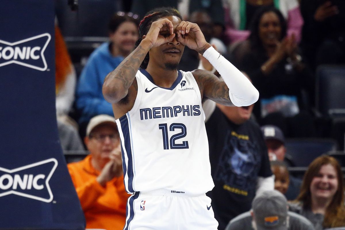 Oct 18, 2024; Memphis, Tennessee, USA; Memphis Grizzlies guard Ja Morant (12) reacts after a dunk during the first half against the Miami Heat at FedExForum. Mandatory Credit: Petre Thomas-Imagn Images